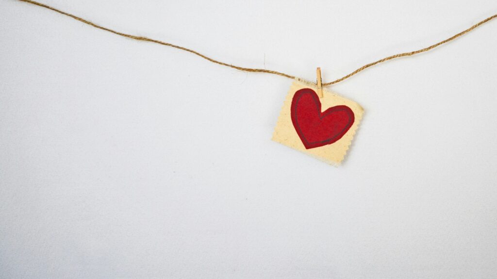 Red heart on a square piece of paper 